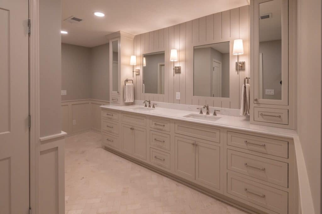 Remodeled primary bathroom with a double vanity and framed mirrors